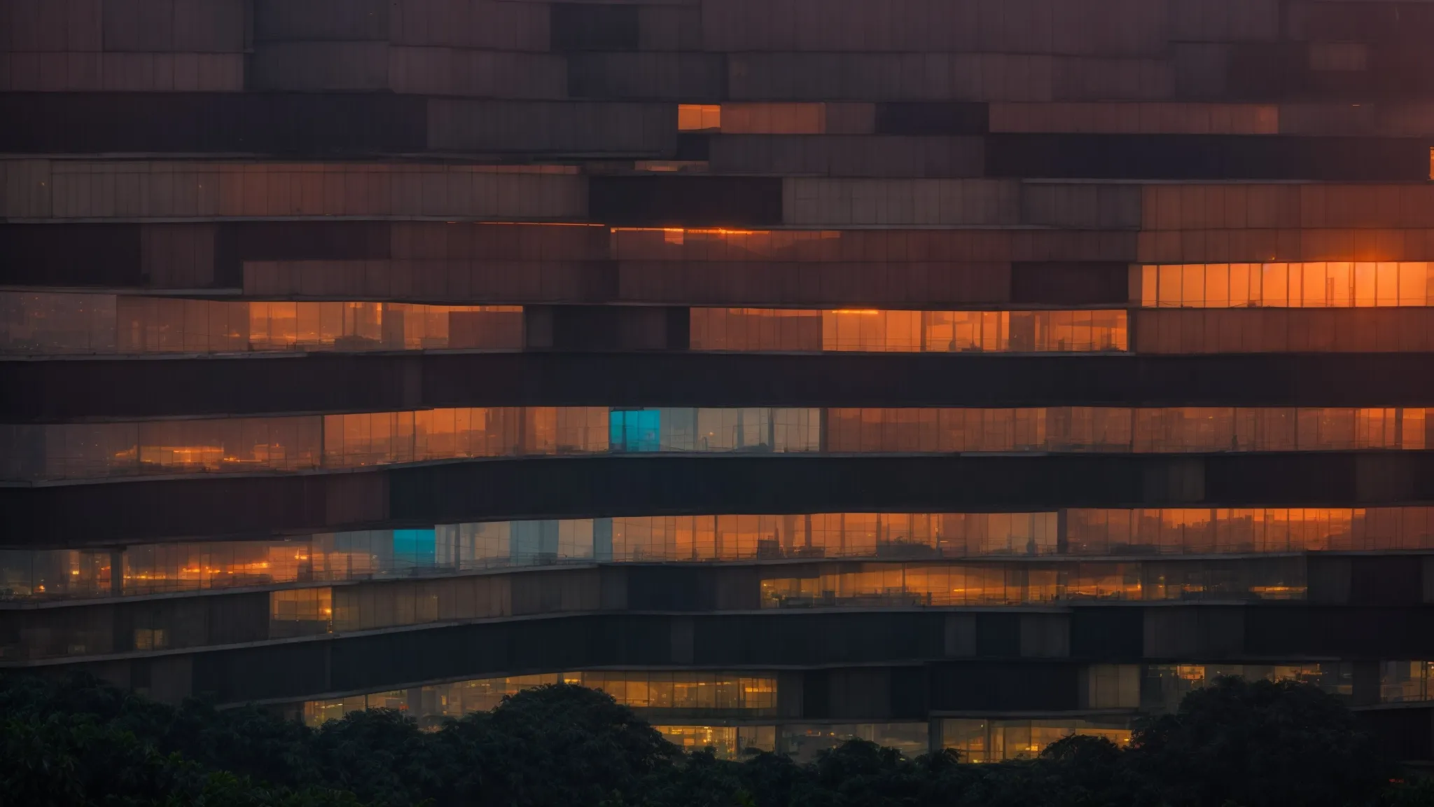 a panoramic view of dhaka's skyline at sunset with glowing screens inside office buildings.