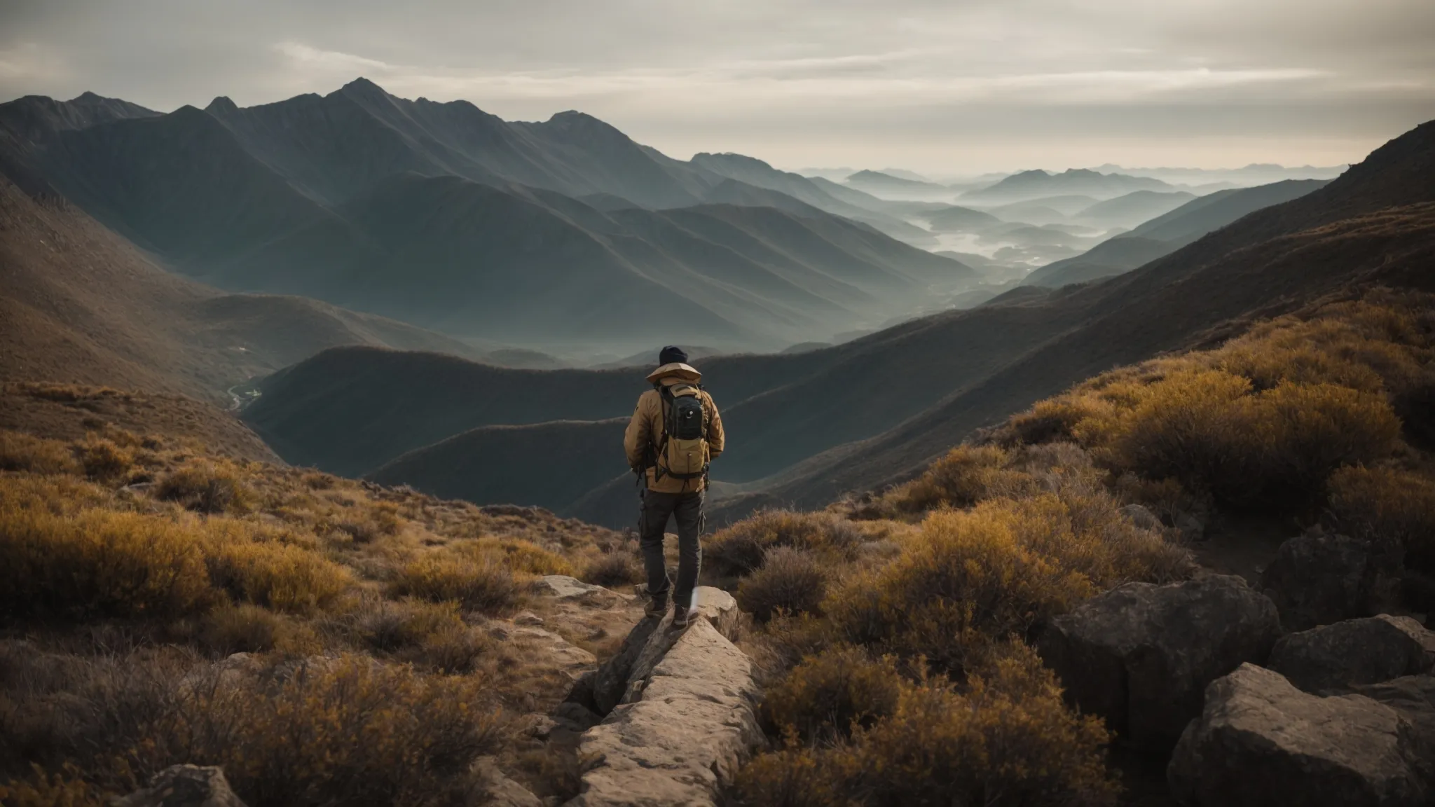 an explorer stands at the apex of a mountain, peering through a spyglass across a vast digital landscape symbolizing the terrain of seo and keyword research.